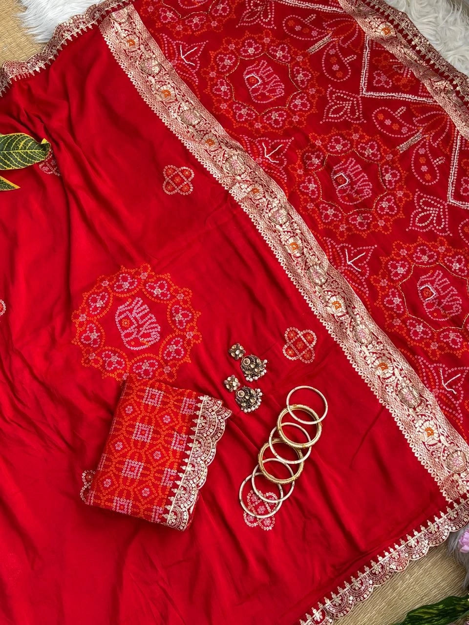 Red bandhani print saree folded with lace blouse piece and bangles – Kalyanja KS408
